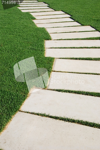 Image of Serpentine pathway stones on a park lawn (concept)