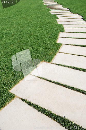 Image of Serpentine pathway stones on a park lawn (concept)