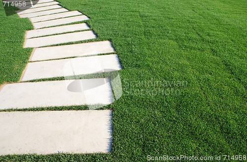 Image of Serpentine pathway stones on a park lawn (concept)