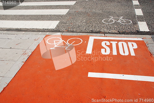 Image of Orange bicycle lane with a STOP sign