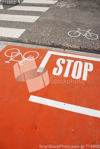 Image of Orange bicycle lane with a STOP sign