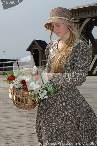 Image of Girl with basket of flowers