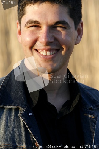 Image of Young handsome man laughing