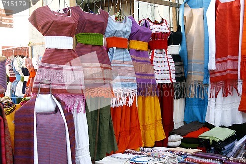 Image of Indigenous handmade Mexican dresses in Oaxaca market, Mexico