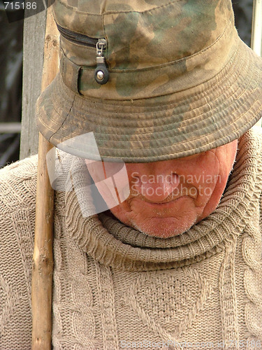 Image of Old man with a hat and a walking stick