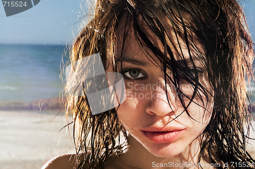 Image of Portrait of the expressive young woman on a beach