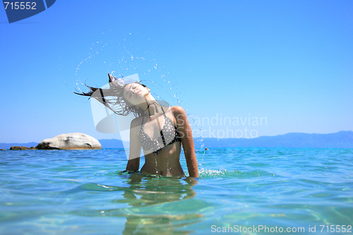 Image of tanned woman in bikini in the sea