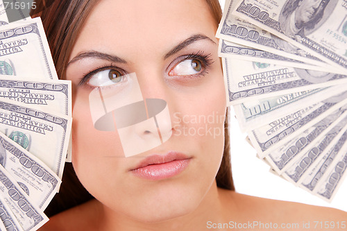 Image of Attractive woman takes lot of 100 dollar bills