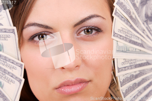 Image of Attractive woman takes lot of 100 dollar bills