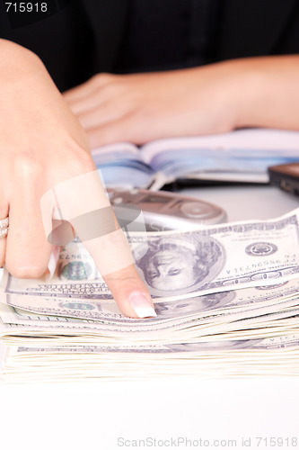 Image of The businesswoman pointing at money