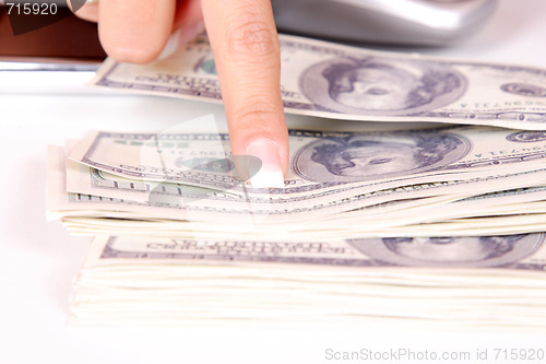 Image of The businesswoman pointing at money