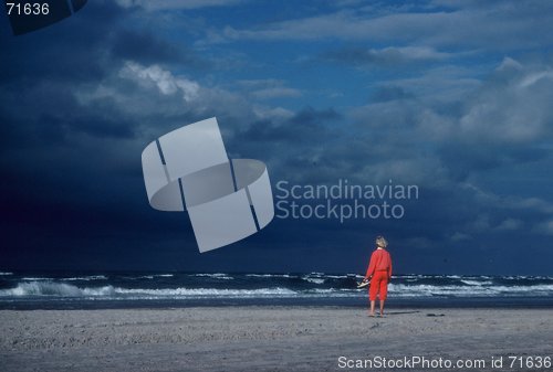 Image of The girl in red, look out the sea