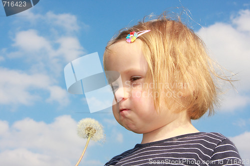 Image of girl blowing dandelion