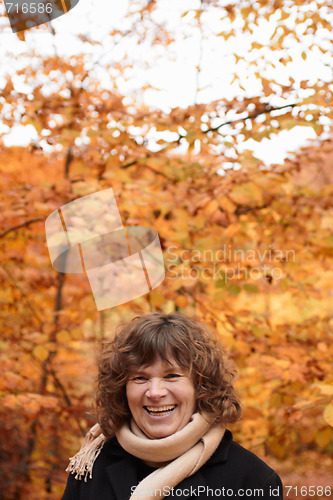 Image of Autumn - happy middle aged woman laughing