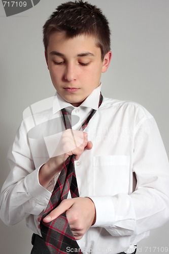 Image of Boy getting dressed for school