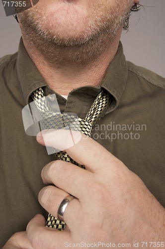 Image of Man Fixing Tie