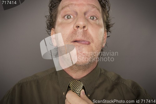 Image of Man Concentrating Fixing Tie