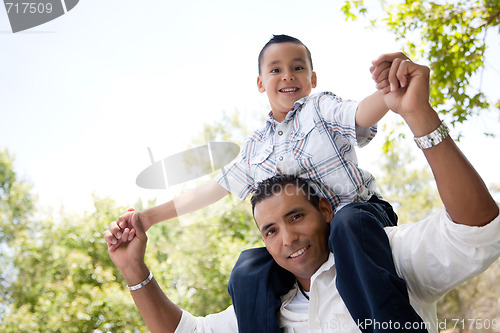 Image of Hispanic Father and Son Having Fun in the Park