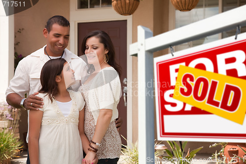 Image of Hispanic Family in Front of Their New Home with Sold Sign