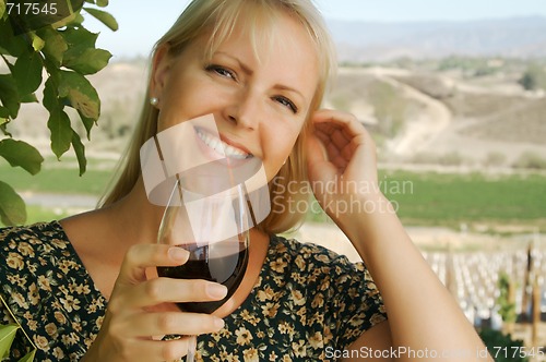 Image of Attractive Woman Sips Wine