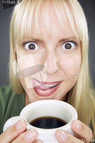 Image of Beautiful Woman Enjoys Coffee