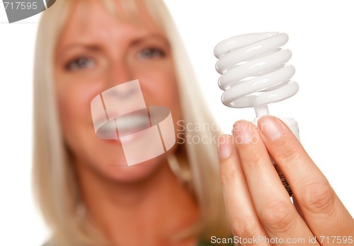 Image of Attractive Blonde Woman Holds Energy Saving Light Bulb