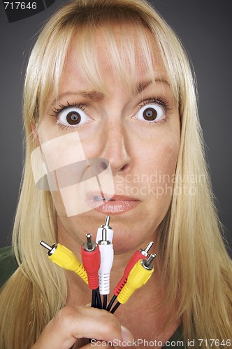 Image of Confused Woman Holding Electronic Cables