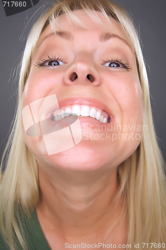 Image of Smiling Blond Woman with Funny Face