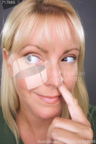 Image of Blond Woman with Finger in Her Nose