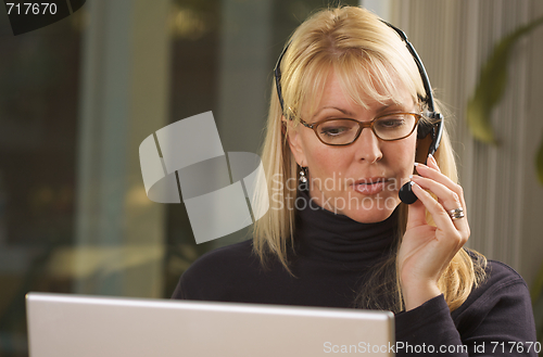 Image of Attractive Businesswoman with Phone Headset