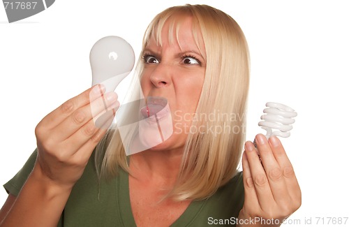 Image of Funny Woman Holding Energy Saving and Regular Light Bulbs