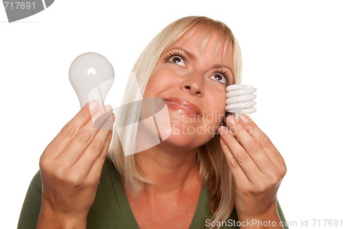 Image of Smiling Woman Holds Energy Saving and Regular Light Bulbs