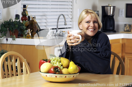 Image of Woman In Kitchen with Cup of Coffee