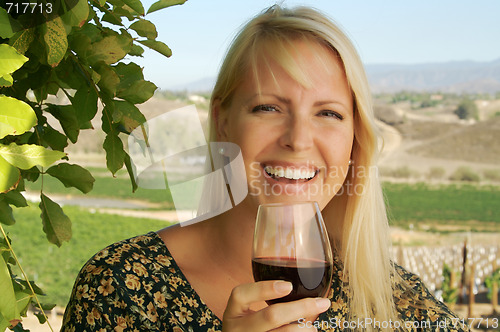 Image of Attractive Woman Sips Wine