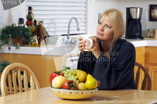 Image of Woman in Kitchen with Cup of Coffee