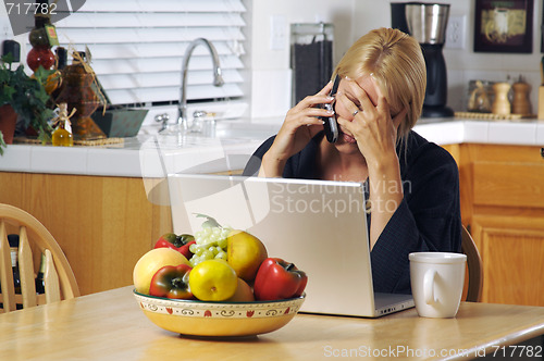 Image of Woman on Cell Phone & Laptop