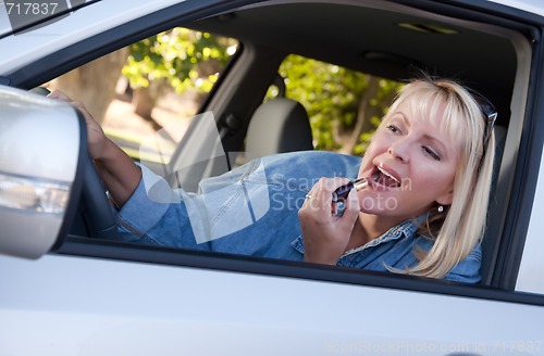 Image of Woman Putting on Lipstick While Driving
