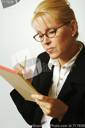 Image of Beautiful Woman Thinks with Pencil & Notepad Taking Notes