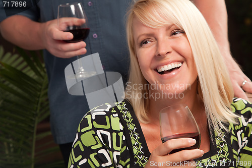 Image of Blonde Socializing with Wine Glass