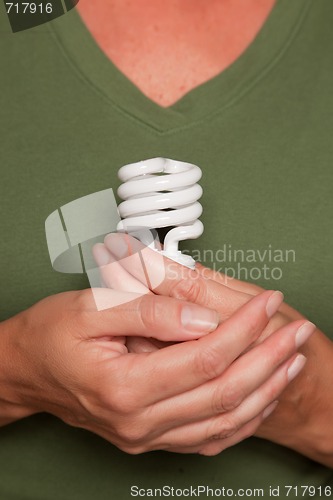 Image of Female Hands Holding Energy Saving Light Bulb