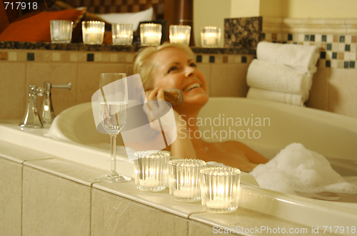 Image of Woman in Bath Using Cell Phone