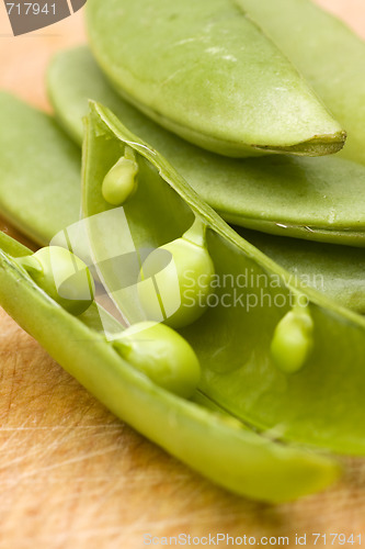 Image of fresh peas on wooden background