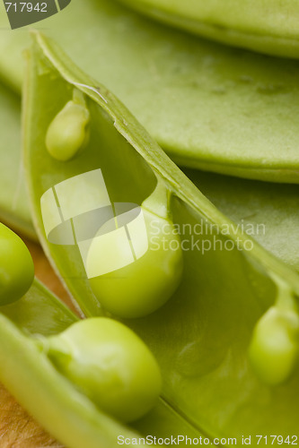 Image of fresh peas on wooden background