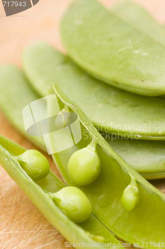 Image of fresh peas on wooden background