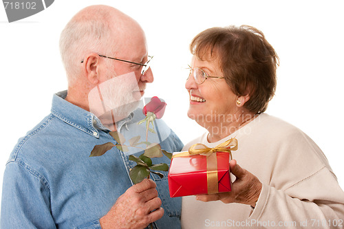 Image of Happy Senior Couple with Gift and Red Rose