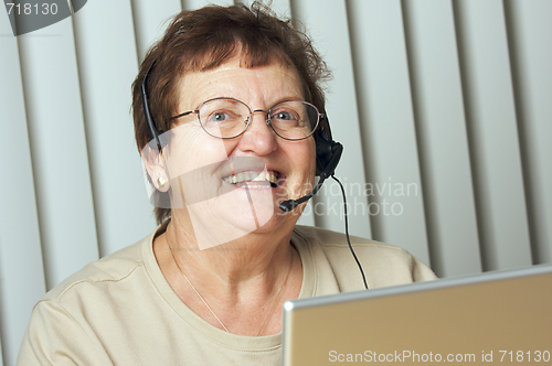 Image of Smiling Senior Adult with Telephone Headset