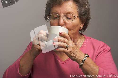 Image of Senior Woman Enjoys Her Coffee