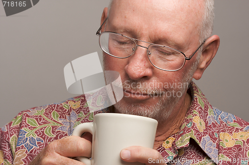 Image of Senior Man Enjoys His Coffee