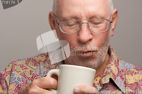 Image of Senior Man Enjoys His Coffee