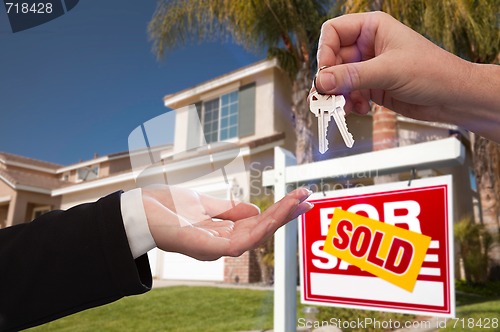 Image of Handing Over the House Keys in Front of New Home